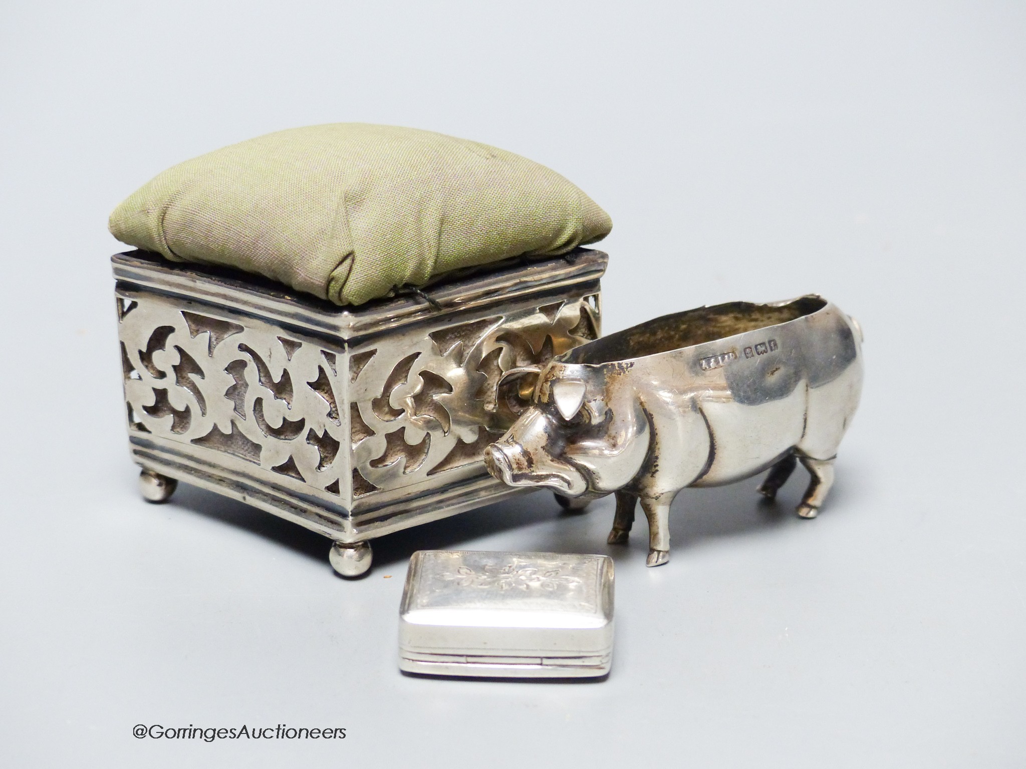 Two silver mounted pin cushions including a pig (lacking cushion) and a 19th century silver vinaigrette.